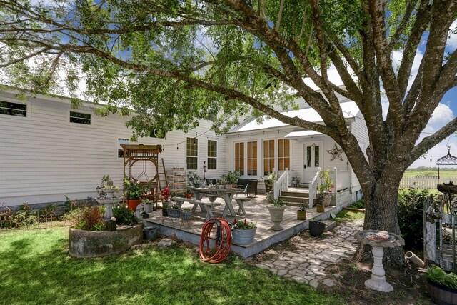back of house with french doors, a yard, and a patio area