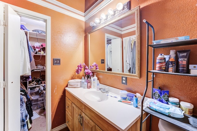 316 Hickman Ln, Angleton, TX 77515 - bathroom featuring vanity, a textured wall, and a walk in closet