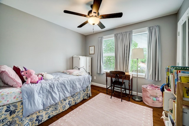 bedroom with baseboards, a ceiling fan, and wood finished floors
