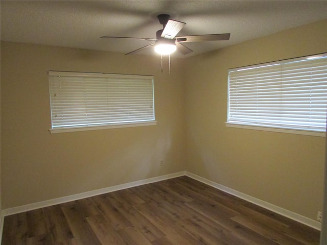 unfurnished room featuring baseboards, a ceiling fan, a textured ceiling, and wood finished floors