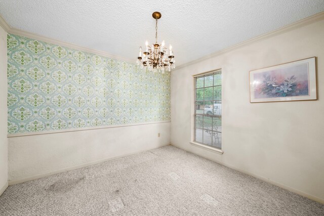 unfurnished room with carpet floors, ornamental molding, wallpapered walls, a textured ceiling, and a notable chandelier