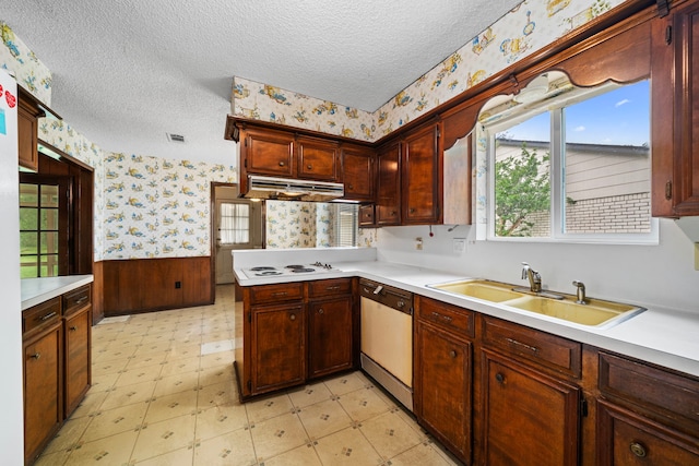 kitchen featuring a sink, light floors, white appliances, and wallpapered walls