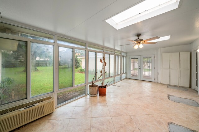 unfurnished sunroom with a skylight, tile patterned flooring, and french doors