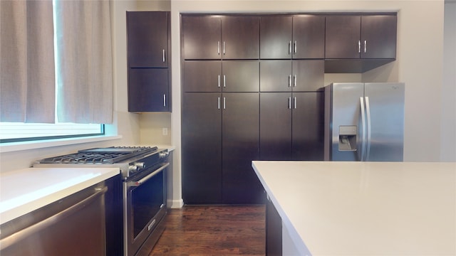 kitchen with light countertops, stainless steel appliances, dark wood-style floors, and dark brown cabinets
