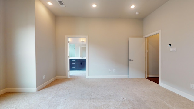 empty room with baseboards and light carpet
