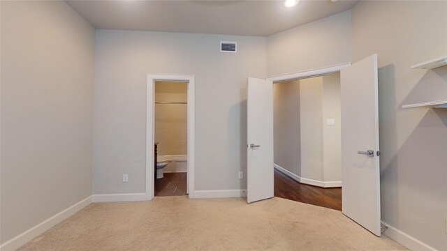 unfurnished bedroom featuring carpet floors, baseboards, recessed lighting, and visible vents