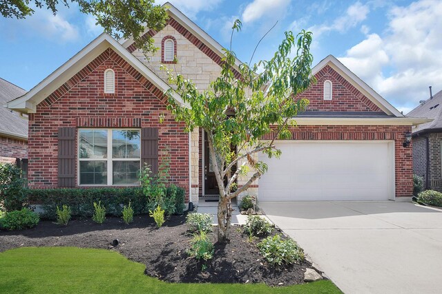 traditional-style home with an attached garage, brick siding, and concrete driveway
