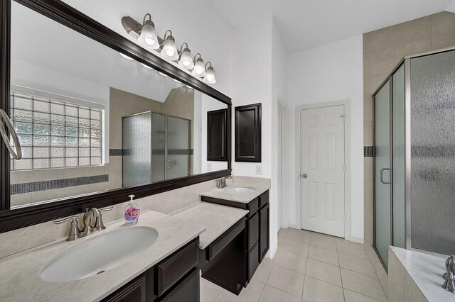 bathroom with tile patterned flooring, a stall shower, and vanity