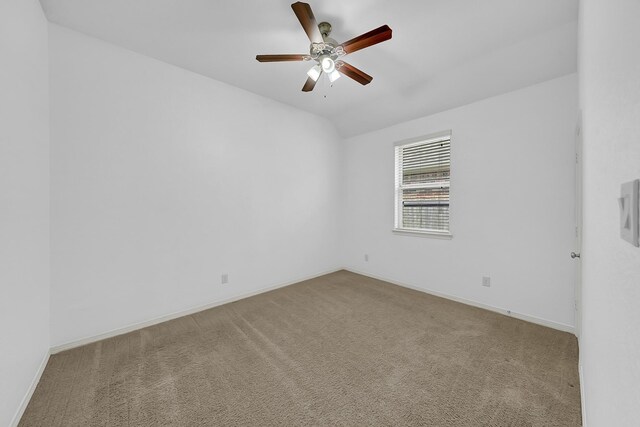 spare room featuring baseboards, ceiling fan, and carpet flooring