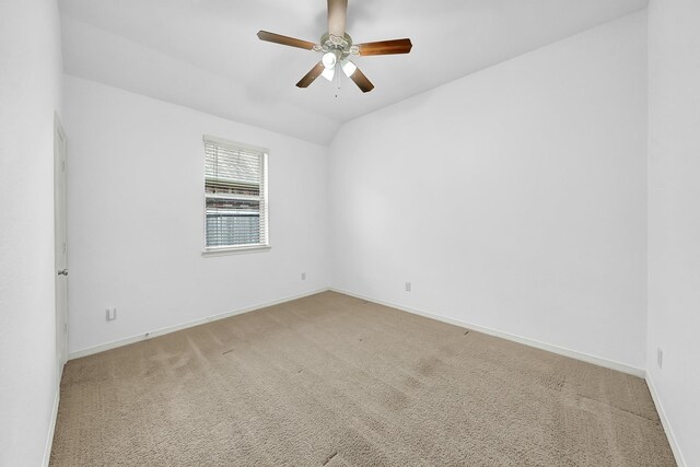 spare room with baseboards, a ceiling fan, and light colored carpet