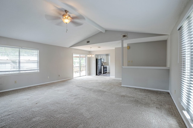 carpeted spare room featuring baseboards, lofted ceiling with beams, ceiling fan with notable chandelier, and visible vents