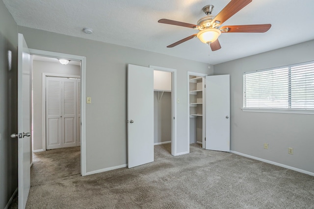 unfurnished bedroom with baseboards, ceiling fan, and carpet