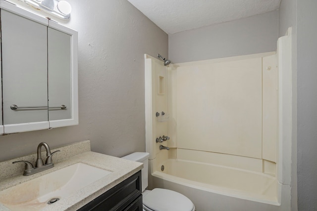 full bath featuring vanity, a textured wall, shower / bathtub combination, toilet, and a textured ceiling