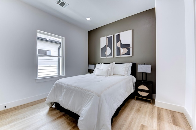 bedroom with visible vents, recessed lighting, light wood finished floors, and baseboards