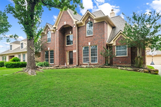 3714 Cedar Glen Ln, Spring, TX 77388 - traditional-style house featuring brick siding, a front lawn, a shingled roof, and a chimney