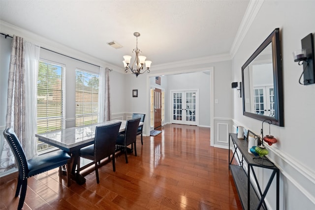 3714 Cedar Glen Ln, Spring, TX 77388 - dining room with a chandelier, crown molding, dark wood-style flooring, and a wainscoted wall