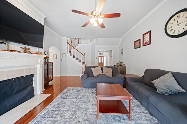 3714 Cedar Glen Ln, Spring, TX 77388 - living room with stairs, crown molding, wood finished floors, a ceiling fan, and a fireplace