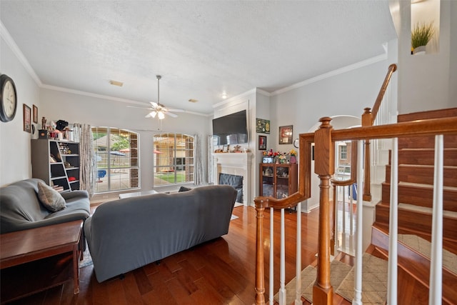 3714 Cedar Glen Ln, Spring, TX 77388 - living room with crown molding, wood finished floors, ceiling fan, a fireplace, and stairway
