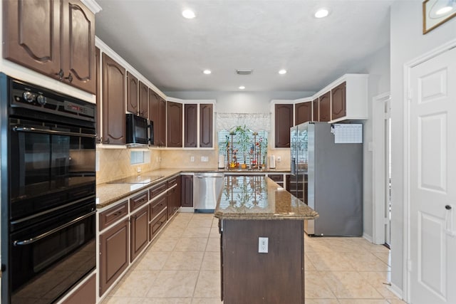 3714 Cedar Glen Ln, Spring, TX 77388 - kitchen with black appliances, light stone counters, a center island, backsplash, and dark brown cabinets