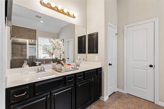 full bathroom featuring double vanity, visible vents, a sink, and a stall shower
