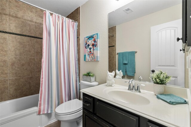 full bath with vanity, shower / bath combo, toilet, and visible vents