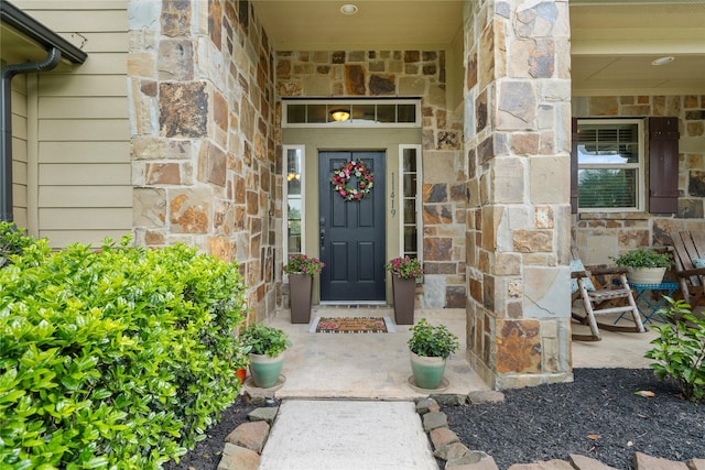 property entrance featuring stone siding