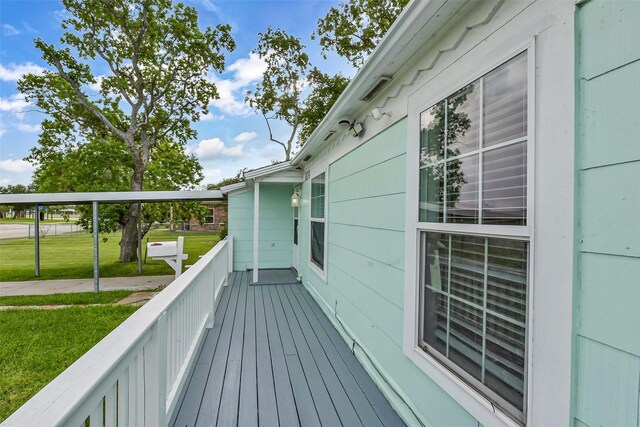 wooden deck with a lawn