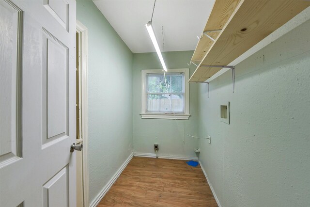 laundry room with baseboards, laundry area, washer hookup, and wood finished floors