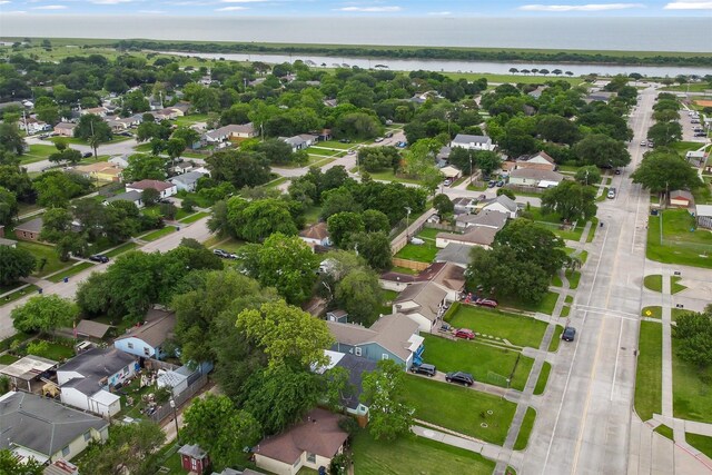 drone / aerial view with a water view and a residential view