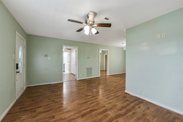 unfurnished living room with baseboards, ceiling fan, wood finished floors, and visible vents