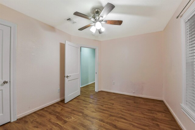 unfurnished bedroom featuring visible vents, baseboards, ceiling fan, and wood finished floors