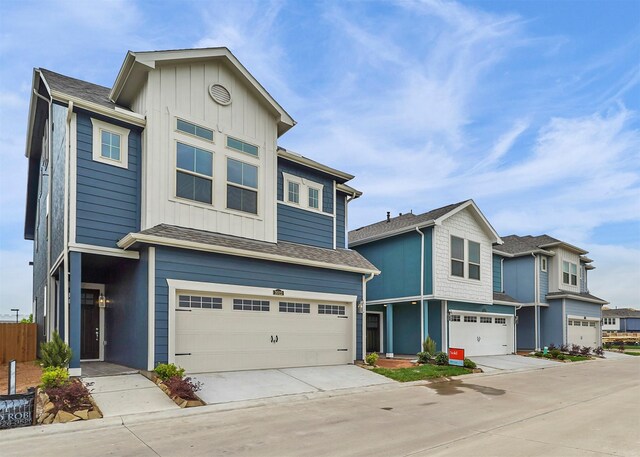 view of front of house with an attached garage, board and batten siding, and driveway