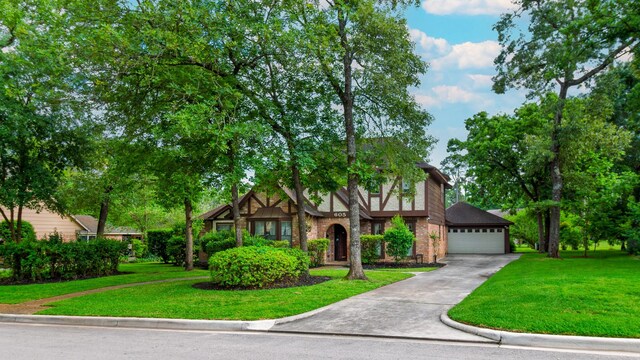 605 N Rivershire Dr, Conroe, TX 77304 - tudor home with a garage and a front yard