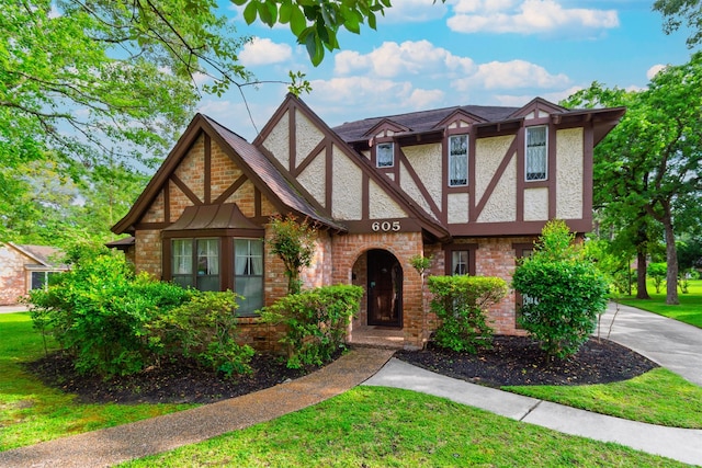 605 N Rivershire Dr, Conroe, TX 77304 - tudor home with stucco siding and a front yard