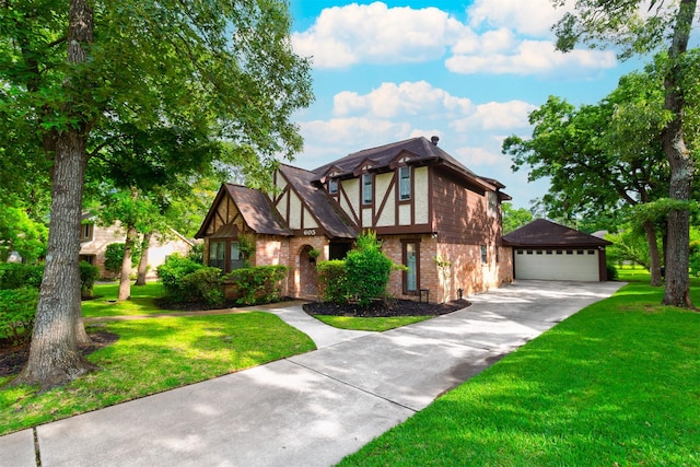 605 N Rivershire Dr, Conroe, TX 77304 - tudor house featuring a garage, an outdoor structure, a front yard, and brick siding