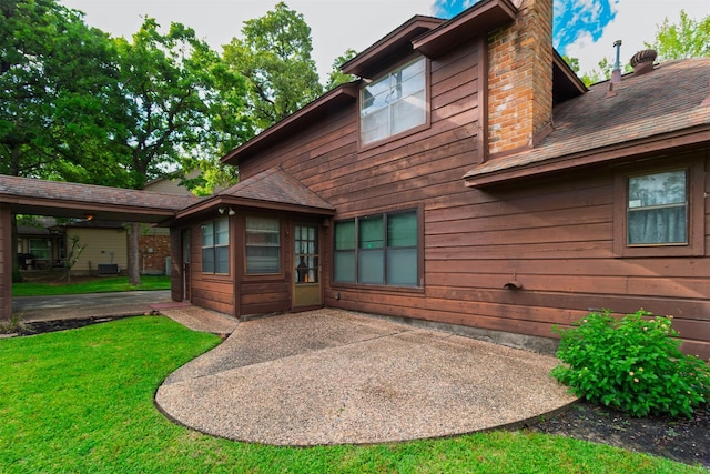 605 N Rivershire Dr, Conroe, TX 77304 - rear view of property with a chimney, a yard, and a patio area