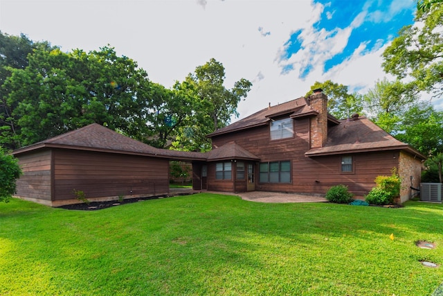 605 N Rivershire Dr, Conroe, TX 77304 - back of house with a lawn, a patio area, a chimney, and cooling unit