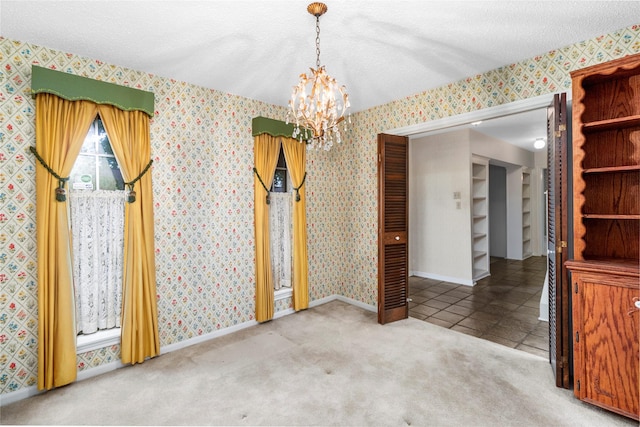 605 N Rivershire Dr, Conroe, TX 77304 - unfurnished dining area with baseboards, carpet flooring, a textured ceiling, and a chandelier