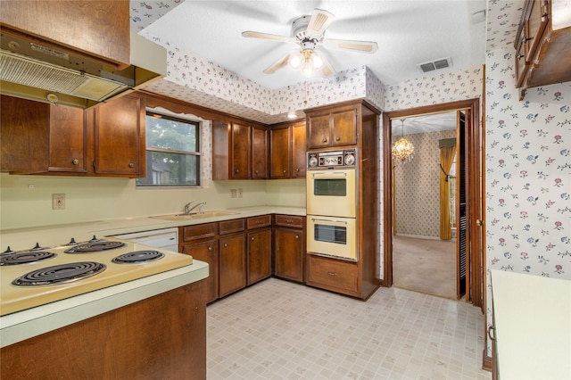 605 N Rivershire Dr, Conroe, TX 77304 - kitchen featuring a sink, double oven, wallpapered walls, and visible vents