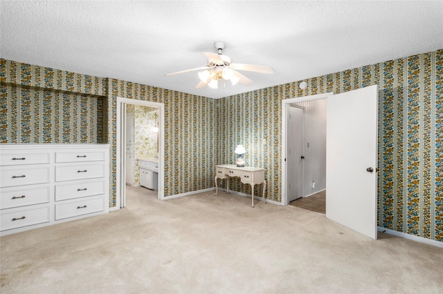 605 N Rivershire Dr, Conroe, TX 77304 - bedroom featuring a textured ceiling, light carpet, and wallpapered walls