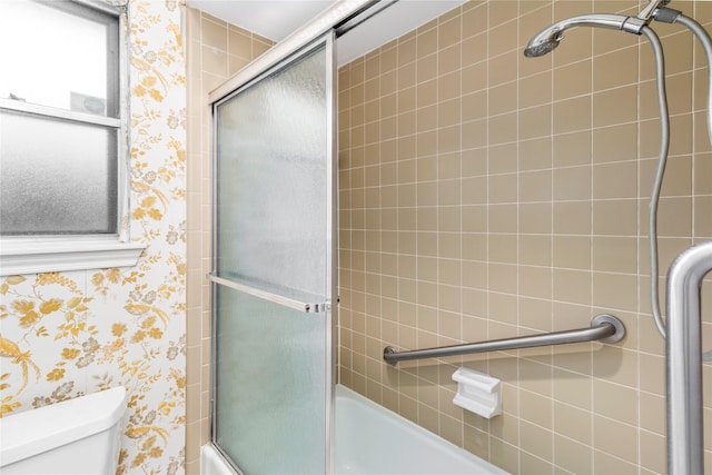 605 N Rivershire Dr, Conroe, TX 77304 - bathroom with toilet, wallpapered walls, and bath / shower combo with glass door