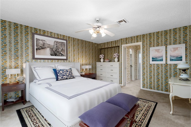 605 N Rivershire Dr, Conroe, TX 77304 - bedroom with visible vents, a textured ceiling, carpet, and wallpapered walls