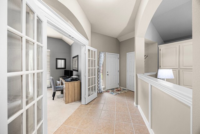 hall with french doors and light tile patterned floors