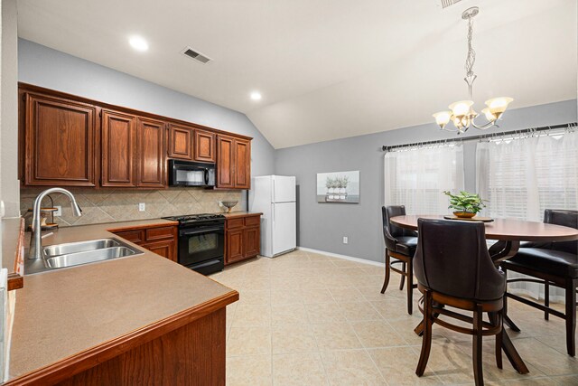 kitchen featuring backsplash, a sink, black appliances, a chandelier, and lofted ceiling