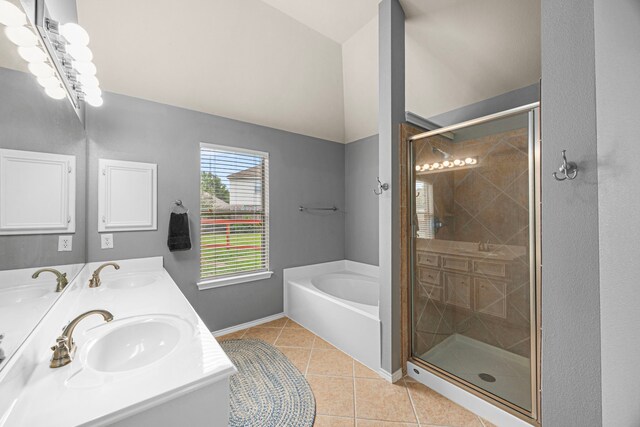 full bathroom featuring tile patterned flooring, a sink, a bath, and a shower stall