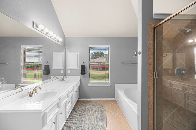 bathroom featuring tile patterned floors, a shower stall, a sink, and lofted ceiling