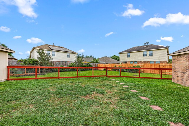 view of yard featuring a residential view and a fenced backyard