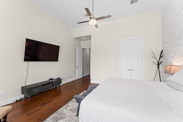 bedroom featuring a ceiling fan, wood finished floors, high vaulted ceiling, baseboards, and a closet