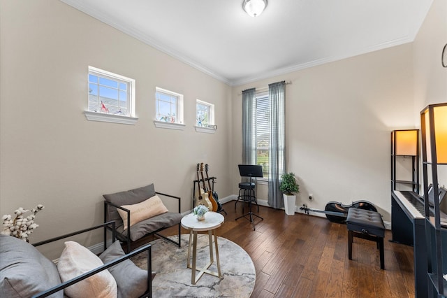 sitting room with crown molding, baseboards, and hardwood / wood-style floors