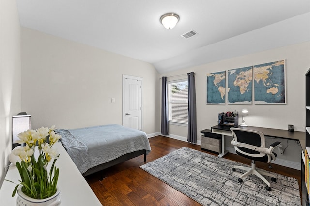 bedroom with baseboards, vaulted ceiling, wood finished floors, and visible vents